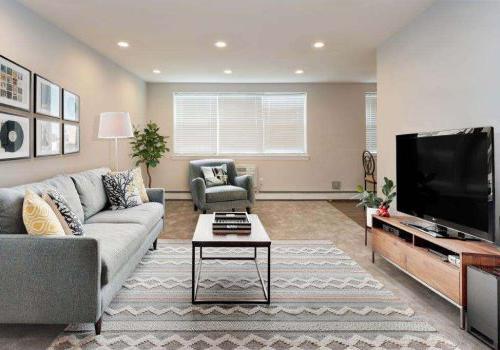 Large living room with a couch, chair, and TV at Willow Bend apartments for rent in Philadelphia, PA